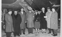 Photograph of Rabbi Silver with other individuals in front of an airplane