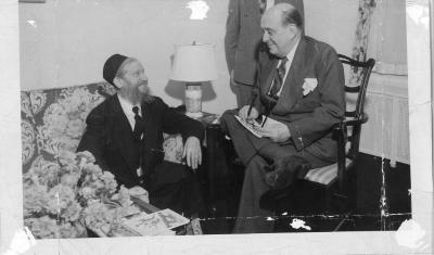 Photograph of Rabbi Eliezer Silver sitting on a couch with another Rabbi