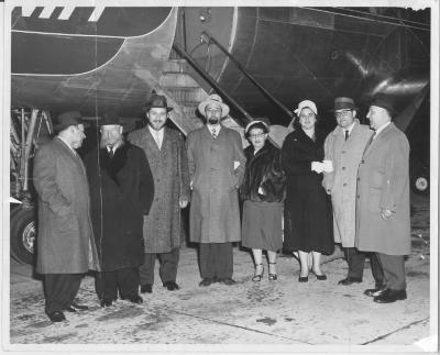 Photograph of Rabbi Silver with other individuals in front of an airplane