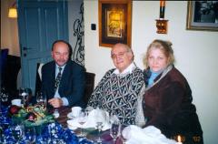 Photo Two Men and a Woman at Table (Finding Family) 