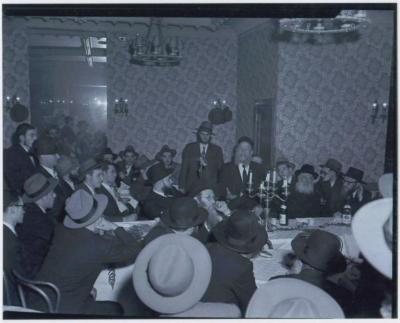 Picture of Rabbi Eliezer Silver Speaking at a Unidentified Wedding, Surrounded by Unidentified Rabbanim