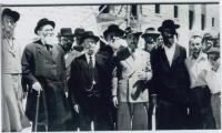 Rabbi Elizer Silver Outdoors in Israel Surrounded by a Group of Unidentified Men